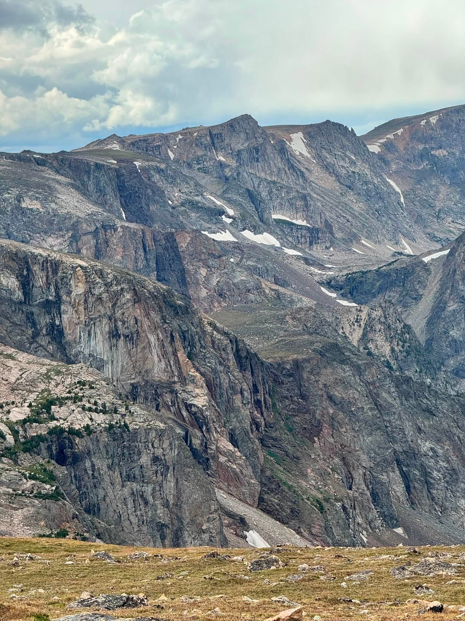 Sheer gray cliffs and snowfields tucked into the high peaks of the Beartooth Mountains